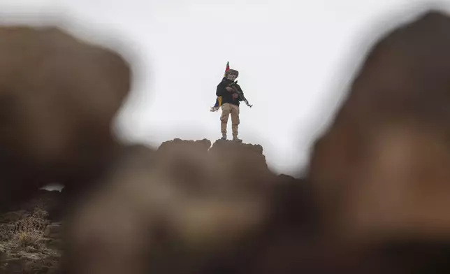 A fighter of the Druze Liwa al-Jabal militia guards on a hilltop near an outpost in Syria's southern province of Sweida, March 4, 2025. (AP Photo/Omar Sanadiki)