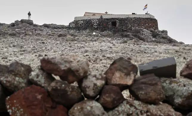 A fighter of the Druze Liwa al-Jabal guards on a hilltop next to an outpost in the southern province of Sweida, Syria, March 4, 2025. (AP Photo/Omar Sanadiki)