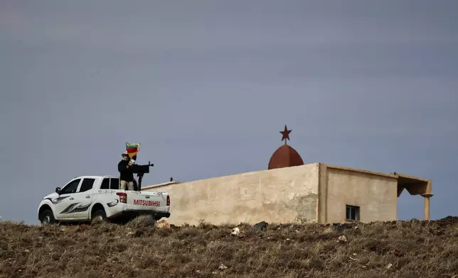 A fighter of the Liwa al-Jabal militia guards a Druze shrine in the southern province of Sweida, Syria, March 4, 2025.(AP Photo/Omar Sanadiki)
