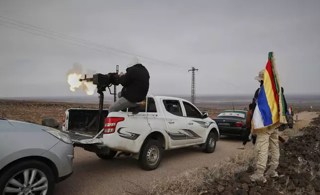 A Druze militiaman fires from a machine-gun attached on the back of a truck during a shooting practice in the southern province of Sweida, Syria, March 4, 2025. (AP Photo/Omar Sanadiki)