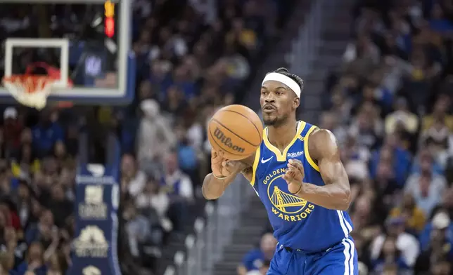 Golden State Warriors forward Jimmy Butler III passes the ball during the first half of an NBA basketball game against the Portland Trail Blazers in San Francisco, Monday, March 10, 2025. (AP Photo/Nic Coury)