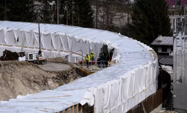 Construction work takes place at the Cortina Sliding Center, venue for the bob, luge and skeleton disciplines at the Milan Cortina 2026 Winter Olympics, in Cortina D'Ampezzo, Italy, Tuesday, March 25, 2025. (AP Photo/Luca Bruno)