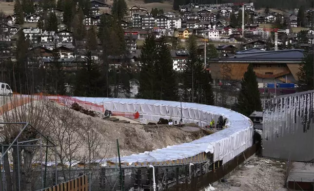 Construction work takes place at the Cortina Sliding Center, venue for the bob, luge and skeleton disciplines at the Milan Cortina 2026 Winter Olympics, in Cortina D'Ampezzo, Italy, Tuesday, March 25, 2025. (AP Photo/Luca Bruno)