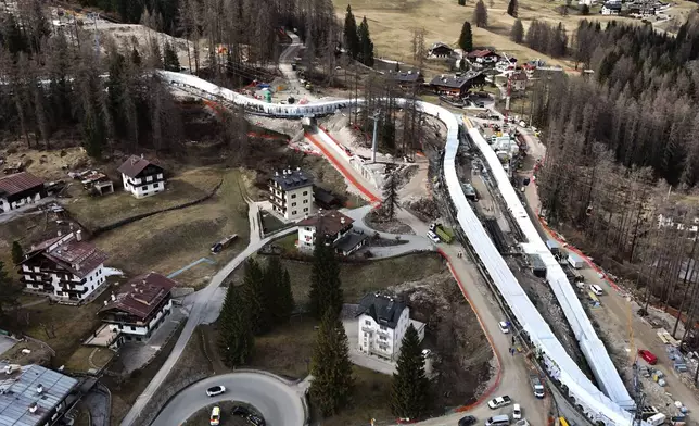 Construction work takes place at the Cortina Sliding Center, venue for the bob, luge and skeleton disciplines at the Milan Cortina 2026 Winter Olympics, in Cortina D'Ampezzo, Italy, Tuesday, March 25, 2025. (AP Photo/Luca Bruno)