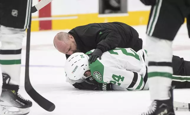Dallas Stars' Roope Hintz (24) is injured after taking a puck to the face against the Edmonton Oilers during the second period of an NHL hockey game in Edmonton, Alberta, Saturday, March 8, 2025. (Jason Franson/The Canadian Press via AP)
