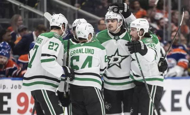 Dallas Stars' Mason Marchment (27), Mikael Granlund (64), Matt Dumba (3), Nils Lundkvist (5) and Matt Duchene (95) celebrate a goal against the Edmonton Oilers during the third period of an NHL hockey game in Edmonton, Alberta, Saturday, March 8, 2025. (Jason Franson/The Canadian Press via AP)