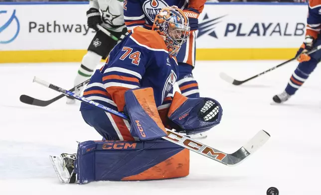 Edmonton Oilers goalie Stuart Skinner (74) makes a save against the Dallas Stars during the first period of an NHL hockey game in Edmonton, Alberta, Saturday, March 8, 2025. (Jason Franson/The Canadian Press via AP)
