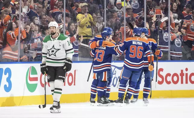 Dallas Stars' Jamie Benn (14) skates past as the Edmonton Oilers celebrate a goal during the first period of an NHL hockey game in Edmonton, Alberta, Saturday, March 8, 2025. (Jason Franson/The Canadian Press via AP)