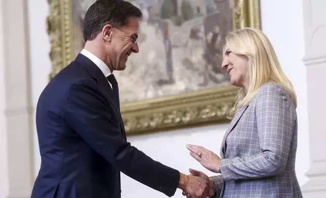 NATO Secretary General Mark Rutte, left, shakes hands with the member of the Bosnian Presidency Zeljka Cvijanovic prior to the start of their meeting in Sarajevo, Bosnia, Monday, March 10, 2025. (AP Photo/Armin Durgut)