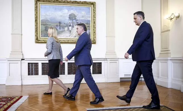 Members of the Bosnian Presidency Zeljka Cvijanovic, left, Zeljko Komsic, center, and Denis Becirovic walk to the photo op with the NATO Secretary General Mark Rutte, prior to the start of their meeting in Sarajevo, Bosnia, Monday, March 10, 2025. (AP Photo/Armin Durgut)