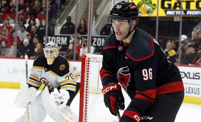 Carolina Hurricanes' Mikko Rantanen (96) concentrates on the puck as Boston Bruins goaltender Joonas Korpisalo (70) looks on during the second period of an NHL hockey game in Raleigh, N.C., Thursday, March 6, 2025. (AP Photo/Karl DeBlaker)