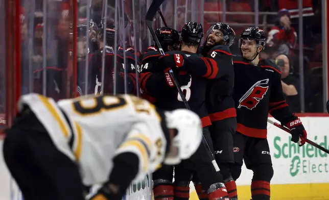 Carolina Hurricanes celebrate after a goal by Seth Jarvis during the third period of an NHL hockey game against the Boston Bruins in Raleigh, N.C., Thursday, March 6, 2025. (AP Photo/Karl DeBlaker)