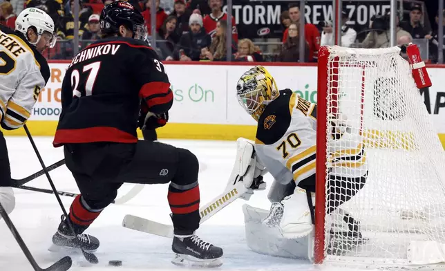 Carolina Hurricanes' Andrei Svechnikov (37) has his shot poked away by Boston Bruins goaltender Joonas Korpisalo (70) during the second period of an NHL hockey game in Raleigh, N.C., Thursday, March 6, 2025. (AP Photo/Karl DeBlaker)