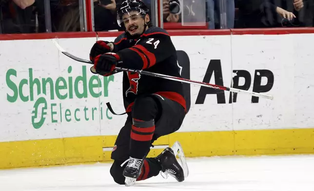 Carolina Hurricanes' Seth Jarvis (24) celebrates his game winning goal against the Boston Bruins during the third period of an NHL hockey game in Raleigh, N.C., Thursday, March 6, 2025. (AP Photo/Karl DeBlaker)