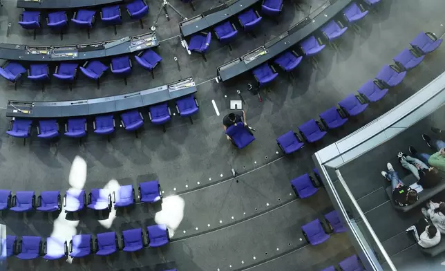 A worker prepares the hall for the new seating of the federal parliament Bundestag at the Reichstag building in Berlin, Germany, Wednesday, March 19, 2025. (AP Photo/Markus Schreiber)