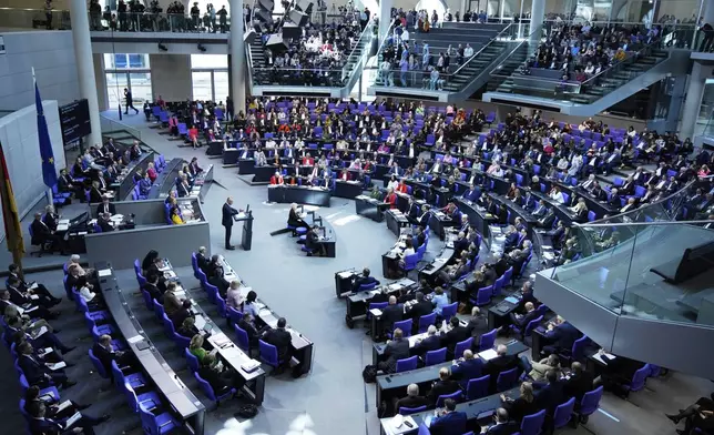 German opposition leader and Christian Democratic Union party chairman Friedrich Merz, right, speaks during a debate and voting about loosen the country's debt rules and change constitution in the German Parliament Bundestag in Berlin, Germany, Tuesday, March 18, 2025. (AP Photo/Ebrahim Noroozi)