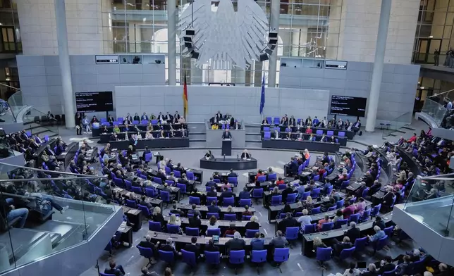German opposition leader and Christian Democratic Union party chairman Friedrich Merz, right, speaks during a debate and voting about loosen the country's debt rules and change constitution in the German Parliament Bundestag in Berlin, Germany, Tuesday, March 18, 2025. (AP Photo/Ebrahim Noroozi)