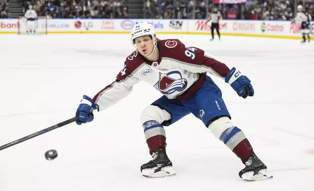 Colorado Avalanche's Joel Kiviranta (94) attempts to intercept a pass during first period NHL hockey action against the Toronto Maple Leafs in Toronto on Wednesday, March 19, 2025. (Christopher Katsarov/The Canadian Press via AP)