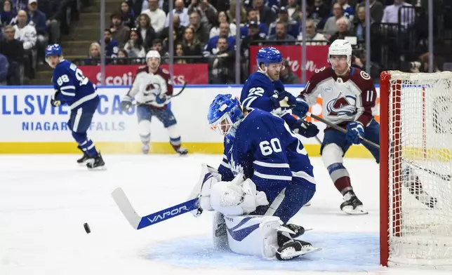 Toronto Maple Leafs goaltender Joseph Woll (60) makes a save during first period NHL hockey action against the Colorado Avalanche in Toronto on Wednesday, March 19, 2025. (Christopher Katsarov/The Canadian Press via AP)