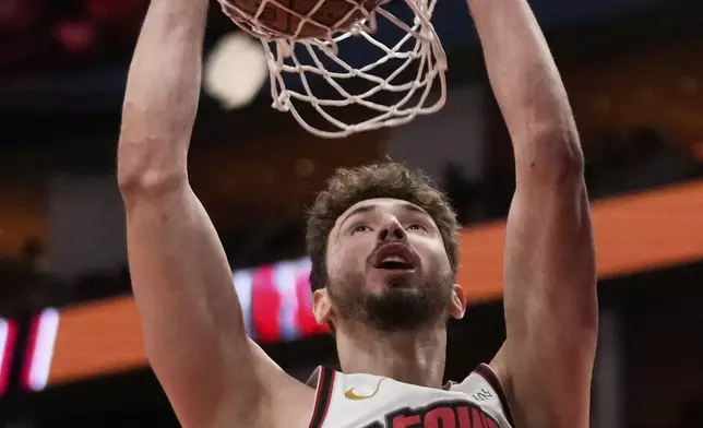 Houston Rockets center Alperen Sengun (28) dunks during the second half of an NBA basketball game in Houston, Sunday, March 23, 2025. (AP Photo/Ashley Landis)