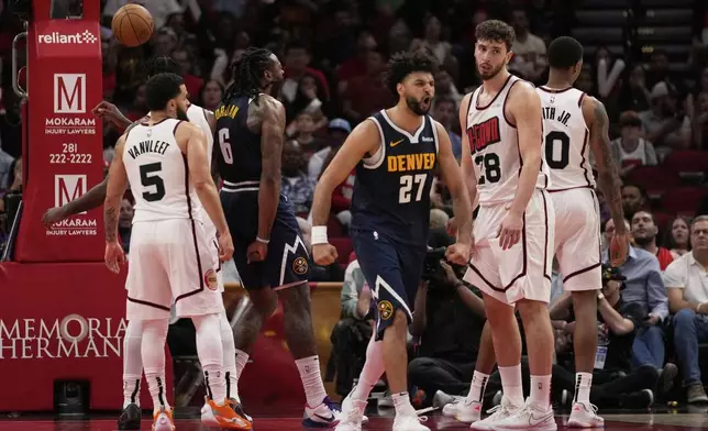 Denver Nuggets center DeAndre Jordan (6) and guard Jamal Murray (27) react after a dunk during the second half of an NBA basketball game against the Houston Rockets in Houston, Sunday, March 23, 2025. (AP Photo/Ashley Landis)