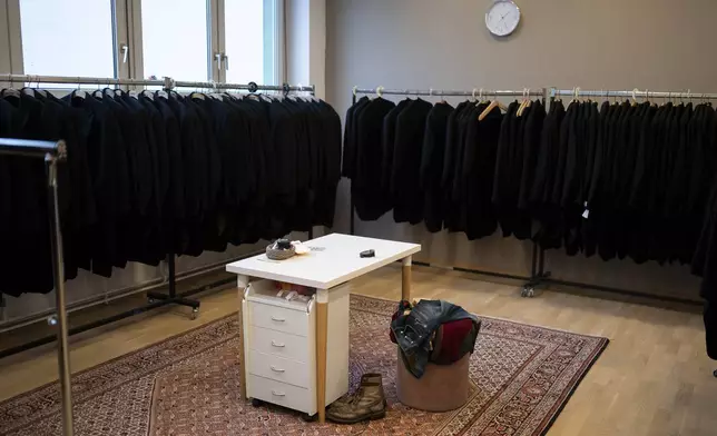 A man's clothes lie in one of the fitting rooms of Lambert Hofer, a renowned costume workshop in Vienna, Austria, Wednesday, Febr 26, 2025. (AP Photo/Denes Erdos)