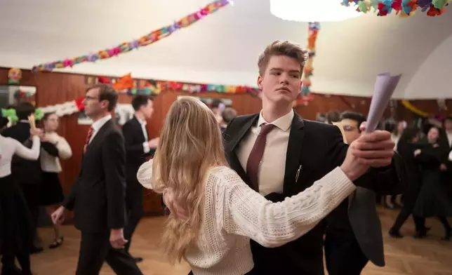 Young people learn to dance waltz during a rehearsal in the Elmayer Dance School in Vienna, Austria, Sunday, Febr 23, 2025. (AP Photo/Denes Erdos)