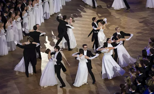 Young people dance waltz during the opening ceremony of the Elmayer-Kränzchen, a Traditional Ball of the Elmayer Dance School in Vienna, Austria, Tuesday, March 4, 2025. (AP Photo/Denes Erdos)