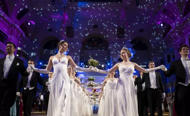 Young people participate in the opening ceremony of the Lawyers' Ball in Vienna, Austria, Saturday, March 1, 2025. (AP Photo/Denes Erdos)