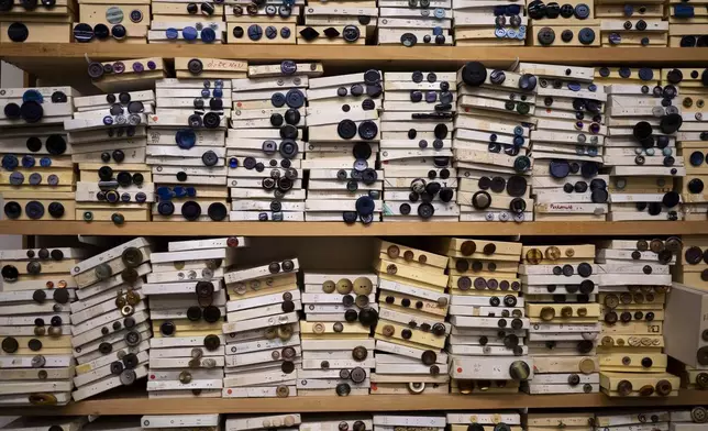 Paper boxes are full of buttons in the workshop of Lambert Hofer, a renowned costume workshop in Vienna, Austria, Wednesday, Febr 26, 2025. (AP Photo/Denes Erdos)