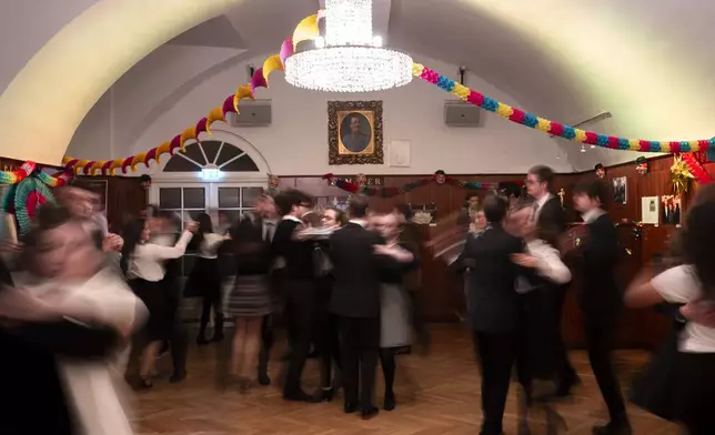 Young people learn to dance waltz during a rehearsal in the Elmayer Dance School in Vienna, Austria, Sunday, Febr 23, 2025. (AP Photo/Denes Erdos)