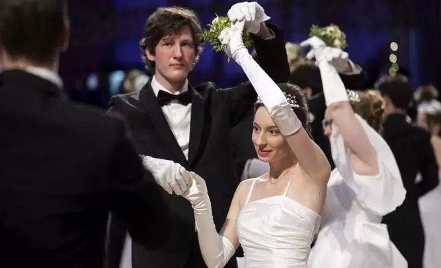 A young couple dance during opening ceremony of the Lawyers' Ball in Vienna, Austria, Saturday, March 1, 2025. (AP Photo/Denes Erdos)