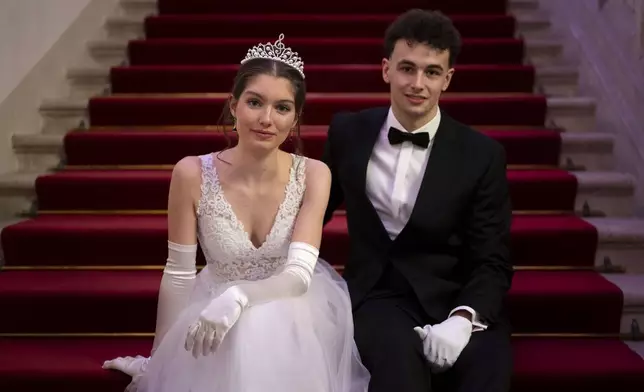 Cornelia Gadermayr, left, and her partner Leander Selmani, right, pose for a photo before the opening ceremony of the Lawyers' Ball in Vienna, Austria, Saturday, March 1, 2025. (AP Photo/Denes Erdos)