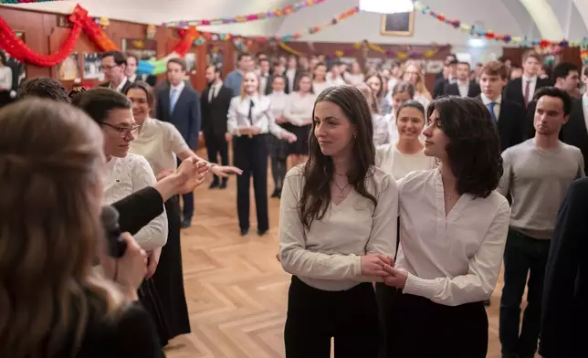 Young people learn the opening choreography for the Lawyers' Ball during a rehearsal in the Elmayer Dance School in Vienna, Austria, Sunday, Febr 23, 2025. (AP Photo/Denes Erdos)