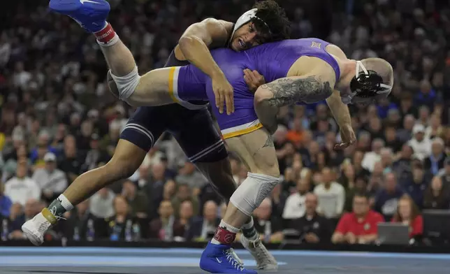 Penn State's Carter Starocci, top, takes on Northern Iowa's Parker Keckeisen during a 184-pound match in the finals at the NCAA wrestling championship, Saturday, March 22, 2025, in Philadelphia. (AP Photo/Matt Rourke)