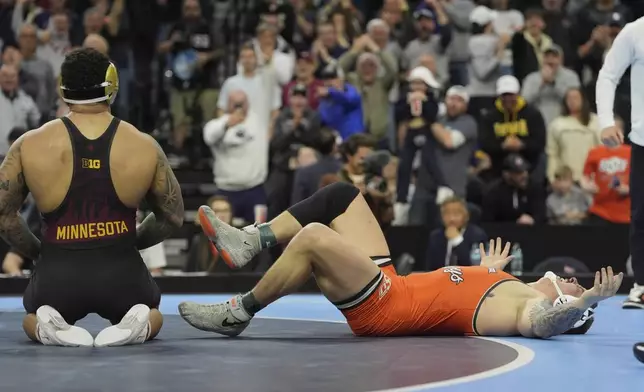 Oklahoma State's Wyatt Hendrickson, right, reacts after defeating Minnesota's Gable Steveson during a 285-pound match in the finals at the NCAA wrestling championship, Saturday, March 22, 2025, in Philadelphia. (AP Photo/Matt Rourke)