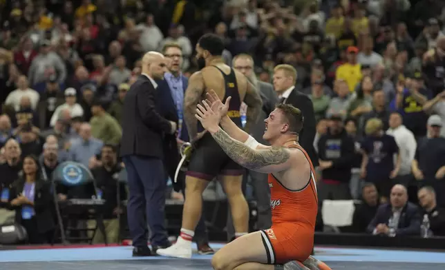 Oklahoma State's Wyatt Hendrickson reacts after defeating Minnesota's Gable Steveson during a 285-pound match in the finals at the NCAA wrestling championship, Saturday, March 22, 2025, in Philadelphia. (AP Photo/Matt Rourke)