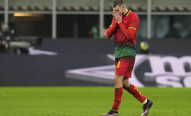 AC Milan's Strahinja Pavlovic walks off the pitch after receiving a red card during the Serie A soccer match between AC Milan and Lazio at the San Siro stadium, in Milan, Italy, Sunday, March 2, 2025. (AP Photo/Antonio Calanni)