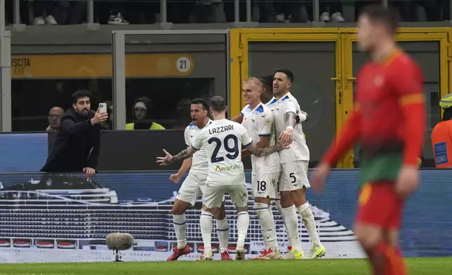 Lazio's Pedro celebrates with teammates after scoring his sides second goal during the Serie A soccer match between AC Milan and Lazio at the San Siro stadium, in Milan, Italy, Sunday, March 2, 2025. (AP Photo/Antonio Calanni)