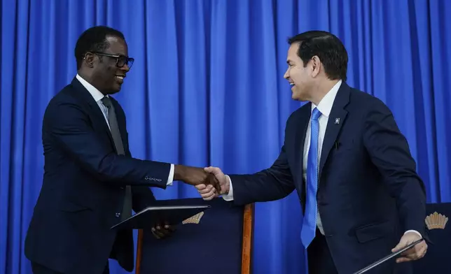 U.S. Secretary of State Marco Rubio and Guyanese Foreign Minister Hugh Todd shake hands as they sign Security Memorandum of Understanding, in Georgetown, Guyana, Thursday, March 27, 2025. (Nathan Howard/Pool photo via AP)