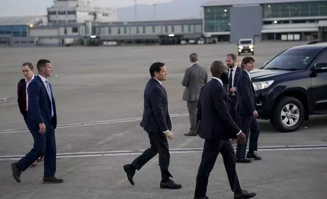 U.S. Secretary of State Marco Rubio walks toward a plane en route to Georgetown, Guyana, as he departs from Norman Manley International Airport in Kingston, Jamaica, Thursday, March 27, 2025. (Nathan Howard/Pool photo via AP)