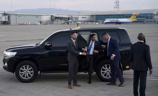U.S. Secretary of State Marco Rubio exits a vehicle to board a plane en route to Georgetown, Guyana, as he departs from Norman Manley International Airport in Kingston, Jamaica, Thursday, March 27, 2025. (Nathan Howard/Pool photo via AP)