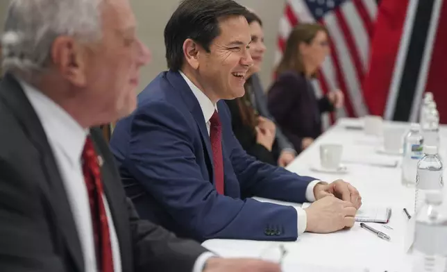 U.S. Secretary of State Marco Rubio smiles during a meeting with Trinidad and Tobago Prime Minister Stuart Young at the U.S. embassy in Kingston, Jamaica, Wednesday, March 26, 2025. (Nathan Howard/Pool Photo via AP)
