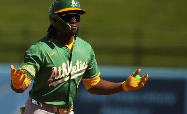 Athletics' Lawrence Butler reacts after hitting a single against the Kansas City Royals during the first inning of a spring training baseball game Monday, Feb. 24, 2025, in Surprise, Ariz. (AP Photo/Lindsey Wasson)