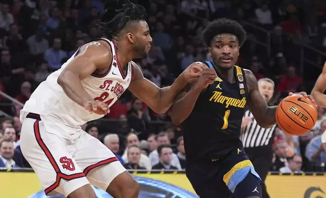 St. John's's Zuby Ejiofor (24) defends Marquette's Kam Jones (1) during the second half of an NCAA college basketball game in the semifinals of the Big East tournament Friday, March 14, 2025, in New York. (AP Photo/Frank Franklin II)
