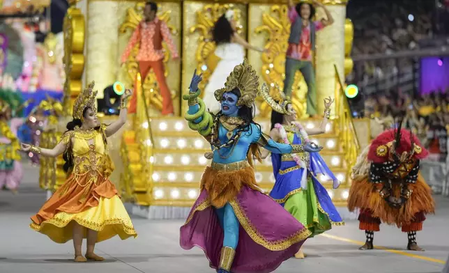 Dancers from the Colorado do Bras samba school perform during a carnival parade in Sao Paulo, Friday, Feb. 28, 2025. (AP Photo/Andre Penner)
