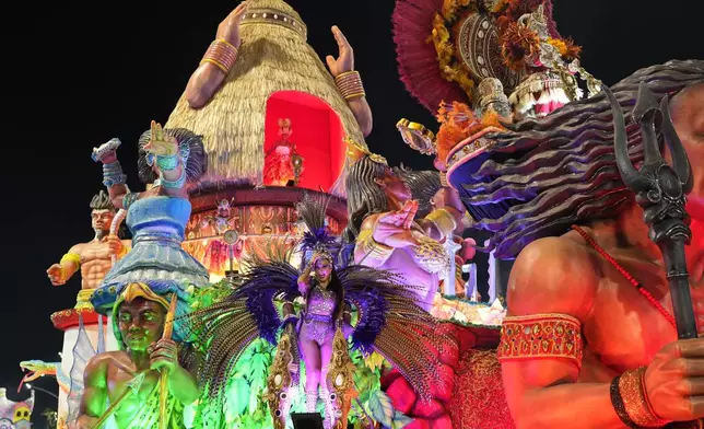 A dancer from the Colorado do Bras samba school performs on a float during a carnival parade in Sao Paulo, Friday, Feb. 28, 2025. (AP Photo/Andre Penner)