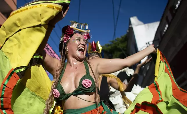 A reveler performs on stilts during the "Ceu na Terra" or "Heaven on Earth" Carnival street party in Rio de Janeiro, Saturday, March 1, 2025. (AP Photo/Bruna Prado)