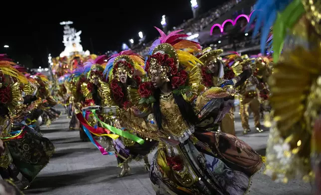 Performers from the Beija-Flor samba school dance during Carnival celebrations at the Sambadrome in Rio de Janeiro, early Tuesday, March 4, 2025. (AP Photo/Bruna Prado)