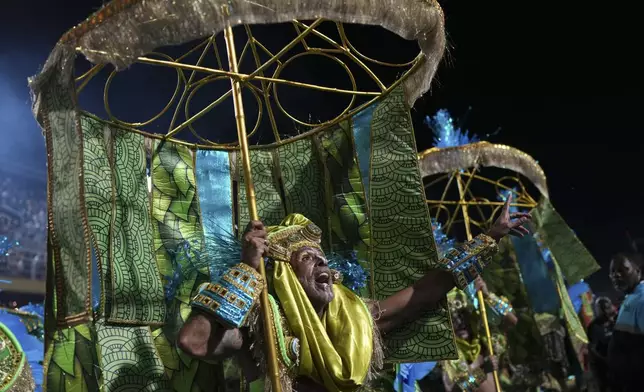 Performers from the Unidos de Padre Miguel samba school parade during Carnival celebrations at the Sambadrome in Rio de Janeiro, Sunday, March 2, 2025. (AP Photo/Silvia Izquierdo)